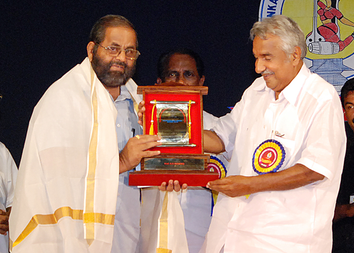 K.P. Babudas receiving  Agamananda award from Oommen Chandy.JPG